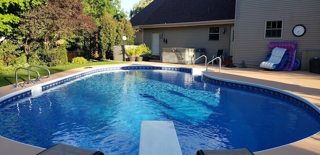 view of swimming pool featuring a fenced in pool, fence, exterior kitchen, a patio area, and a diving board