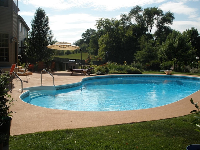 outdoor pool with a patio area