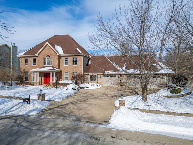 view of front of house with brick siding, driveway, and an attached garage