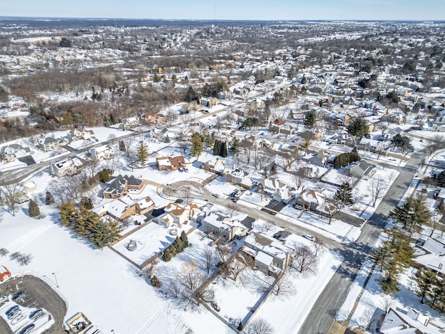 snowy aerial view with a residential view