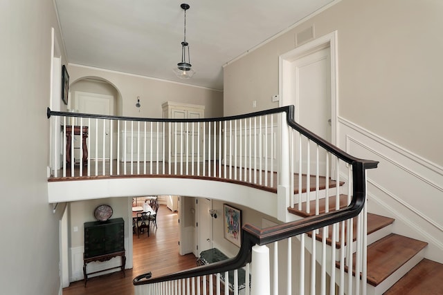 2252 Orrington Ave, Evanston, IL 60201 - staircase featuring crown molding, wood finished floors, and visible vents
