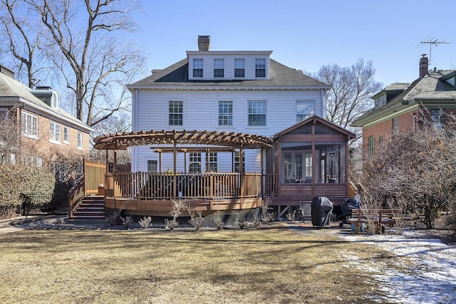 2252 Orrington Ave, Evanston, IL 60201 - back of property with a pergola, a sunroom, a chimney, a deck, and a lawn