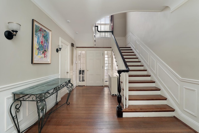 2252 Orrington Ave, Evanston, IL 60201 - entryway featuring wood finished floors, a wainscoted wall, arched walkways, stairs, and a decorative wall