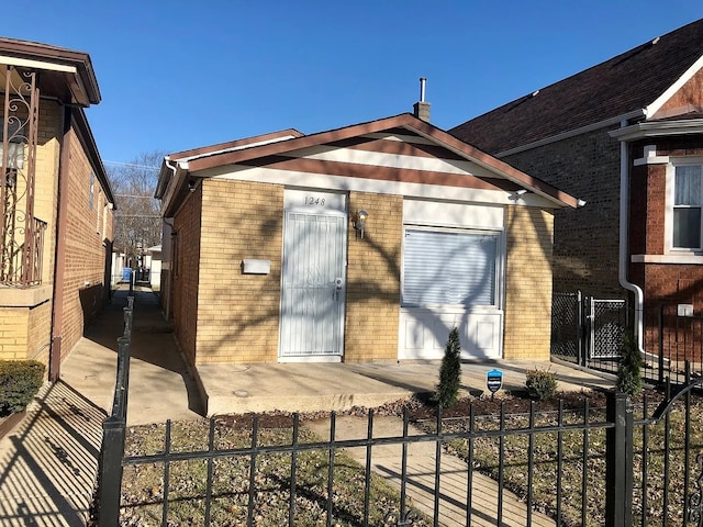 exterior space with a fenced front yard and brick siding