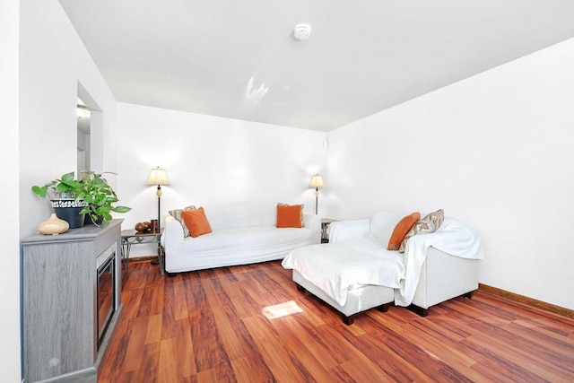 living area with wood finished floors and baseboards