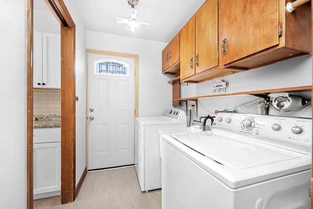 laundry room with cabinet space, light wood-type flooring, and independent washer and dryer