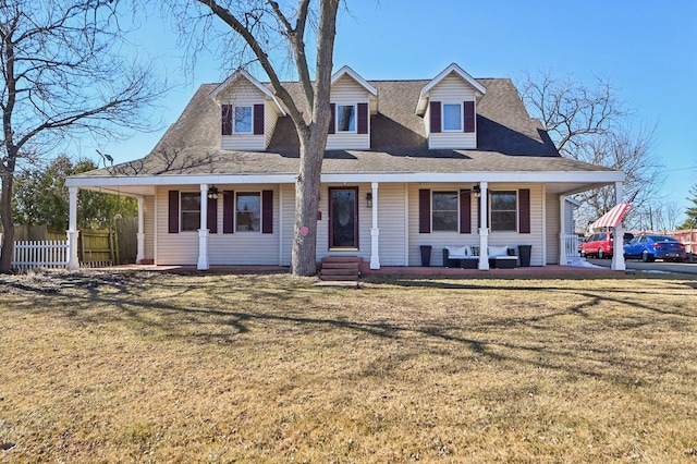 view of front of home with fence, a porch, and a front yard