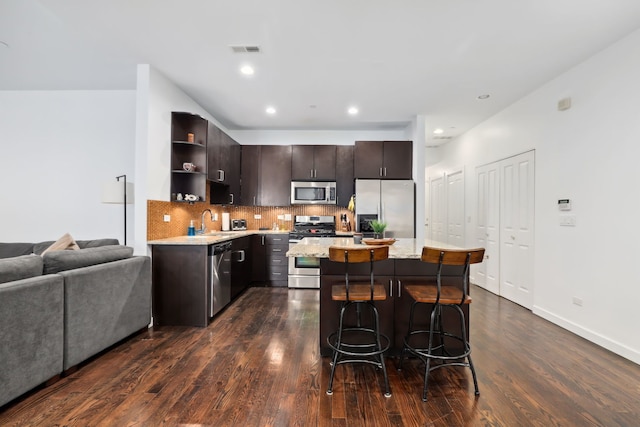 kitchen with visible vents, stainless steel appliances, dark brown cabinets, open shelves, and backsplash