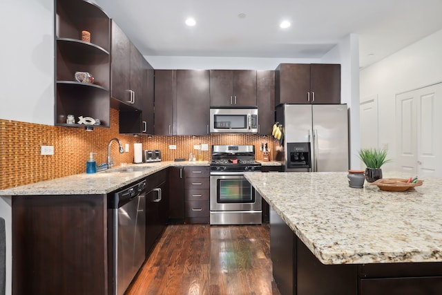 kitchen with dark wood finished floors, open shelves, stainless steel appliances, decorative backsplash, and dark brown cabinetry