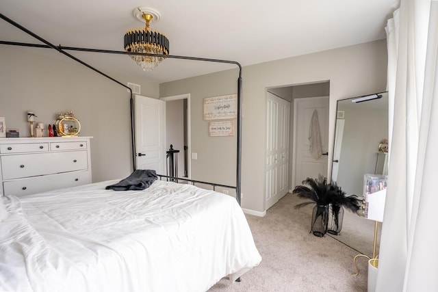 bedroom featuring light carpet, visible vents, and a notable chandelier