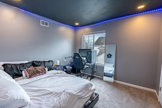 carpeted bedroom featuring visible vents and baseboards