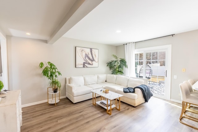 living room featuring light wood-style floors, recessed lighting, beam ceiling, and baseboards