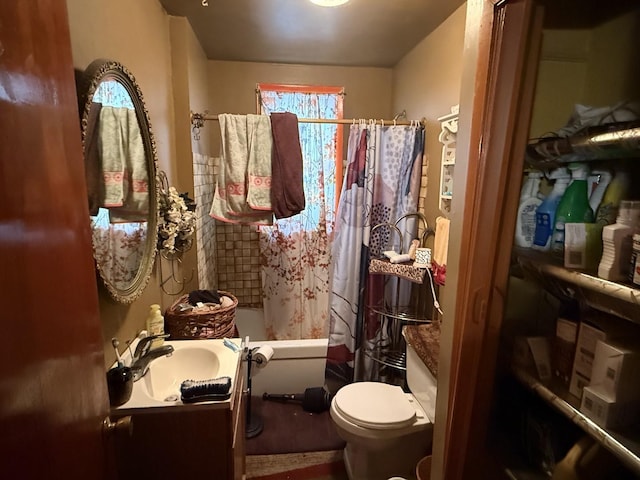 full bathroom featuring shower / tub combo with curtain, vanity, and toilet