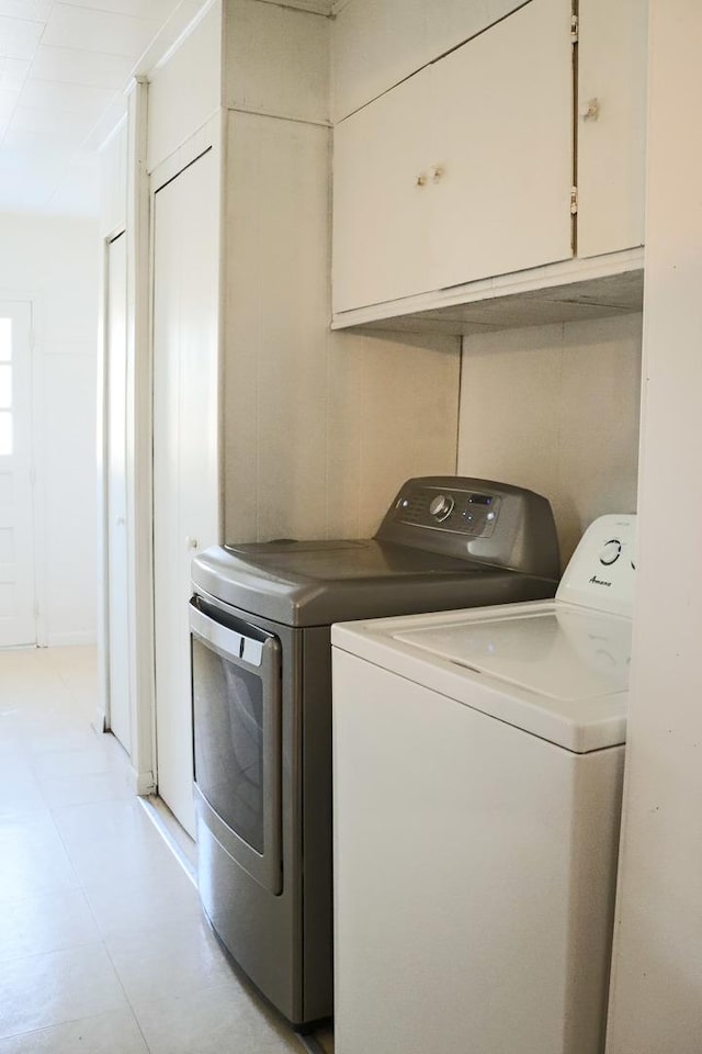 laundry room featuring washing machine and dryer and cabinet space