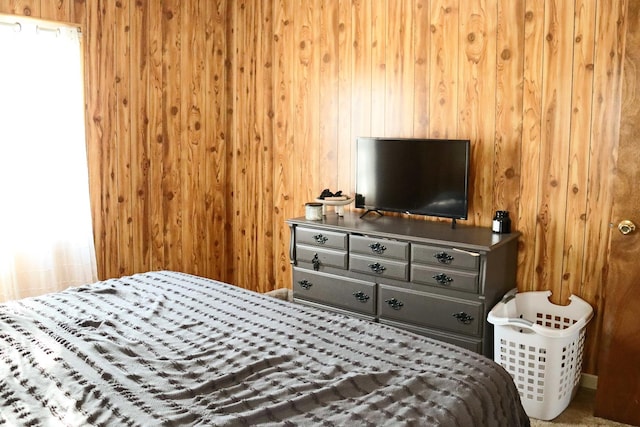 bedroom featuring wood walls