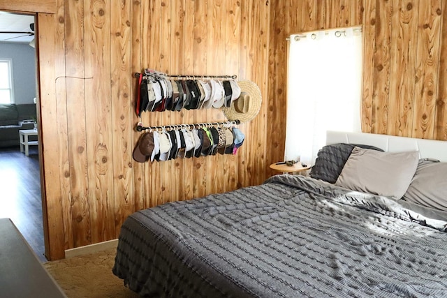 bedroom featuring wood walls