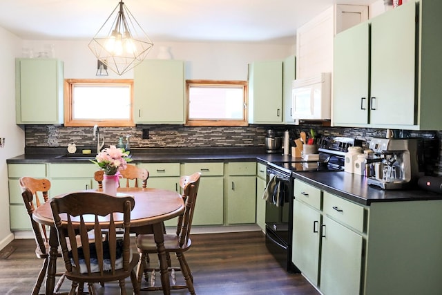 kitchen with dark countertops, white microwave, black range with electric cooktop, and green cabinets