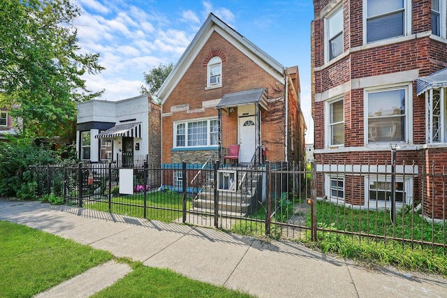 view of front of house with a fenced front yard and brick siding