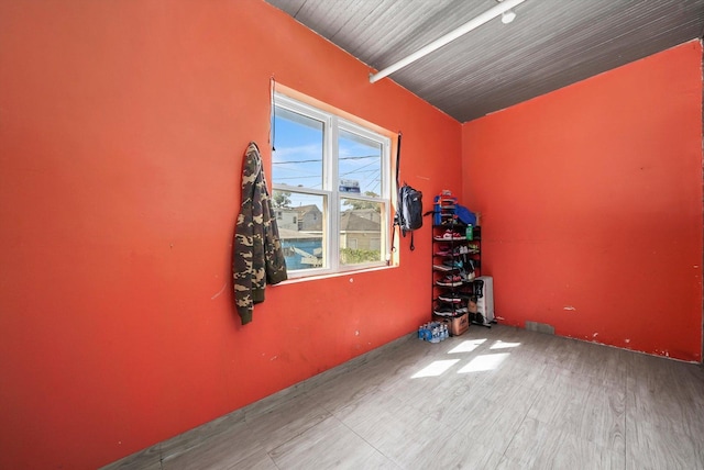 interior space with beamed ceiling and wood finished floors