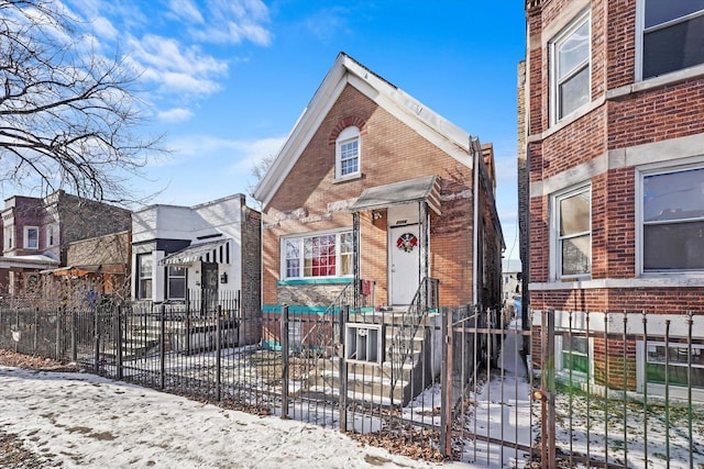 view of front of house featuring a fenced front yard and brick siding