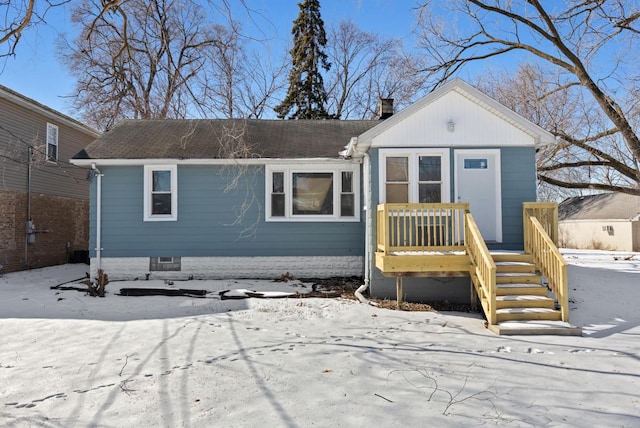 view of front of home featuring a shingled roof and a chimney