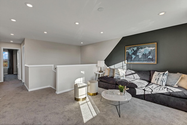 living area featuring baseboards, recessed lighting, and light colored carpet