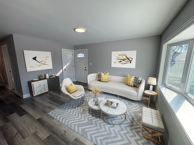 living area featuring dark wood finished floors and baseboards