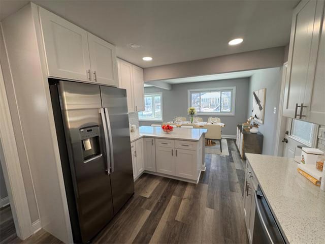 kitchen featuring baseboards, white cabinets, dark wood-style floors, stainless steel appliances, and recessed lighting