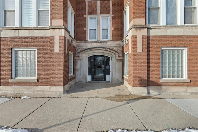 property entrance featuring brick siding