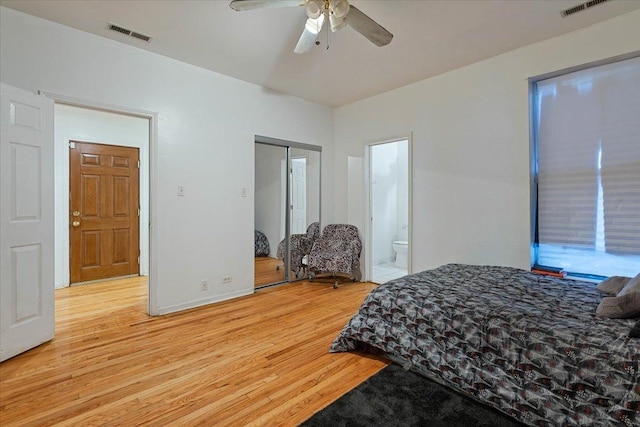 bedroom with visible vents, a ceiling fan, connected bathroom, wood finished floors, and baseboards