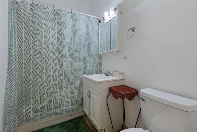 full bathroom with toilet and vanity