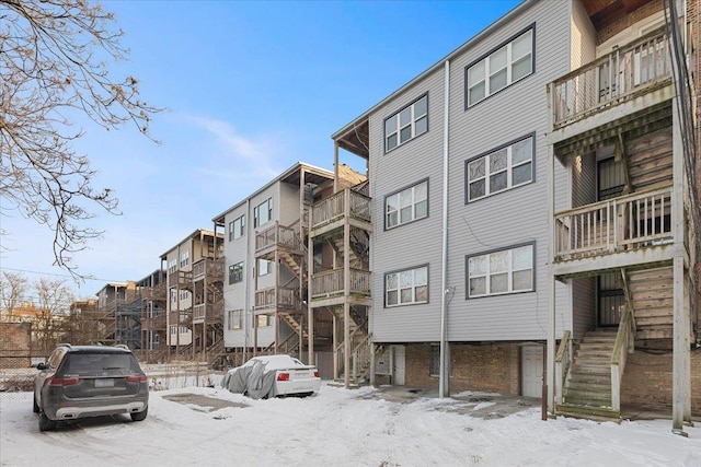 snow covered property featuring stairs