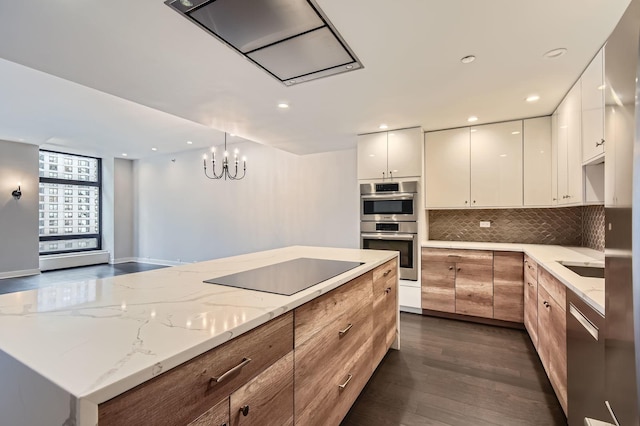 kitchen with light stone counters, dark wood-style floors, appliances with stainless steel finishes, modern cabinets, and tasteful backsplash