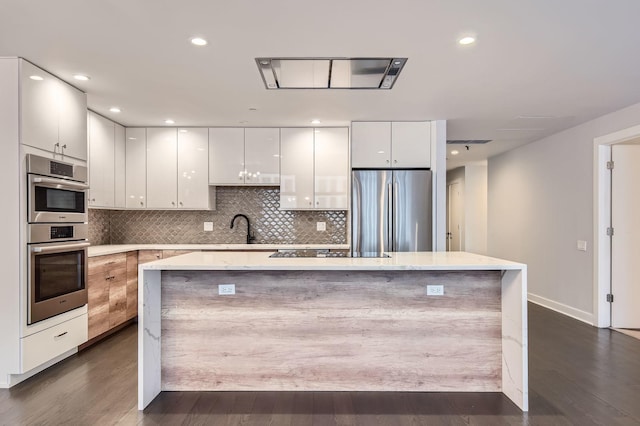 kitchen with backsplash, white cabinetry, appliances with stainless steel finishes, and modern cabinets