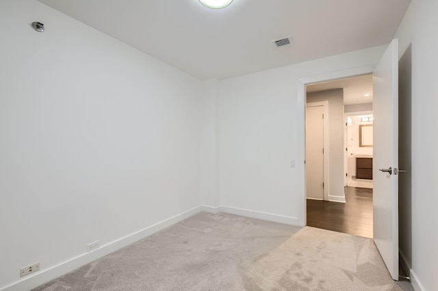 empty room with visible vents, carpet, and baseboards