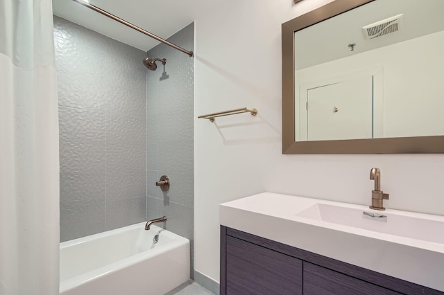 bathroom with visible vents, bathtub / shower combination, and vanity