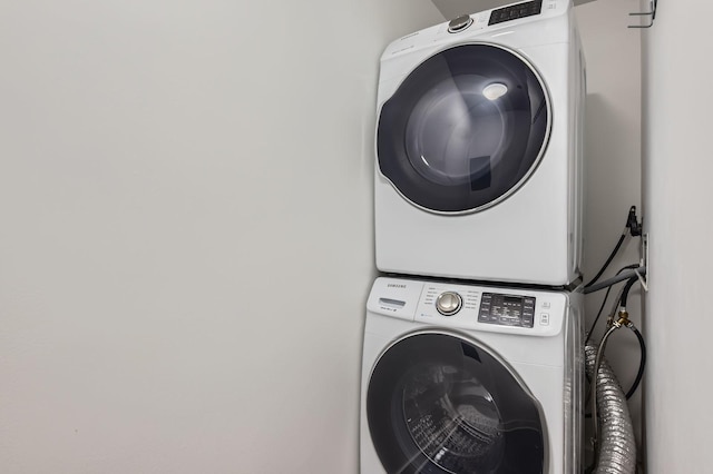 clothes washing area with stacked washer and dryer