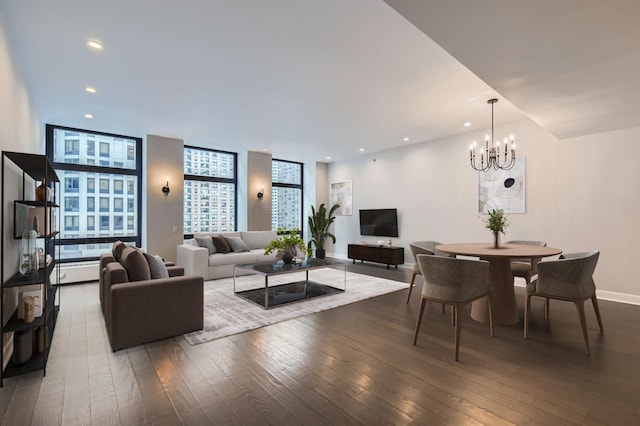 living room with a chandelier, recessed lighting, baseboards, and wood-type flooring