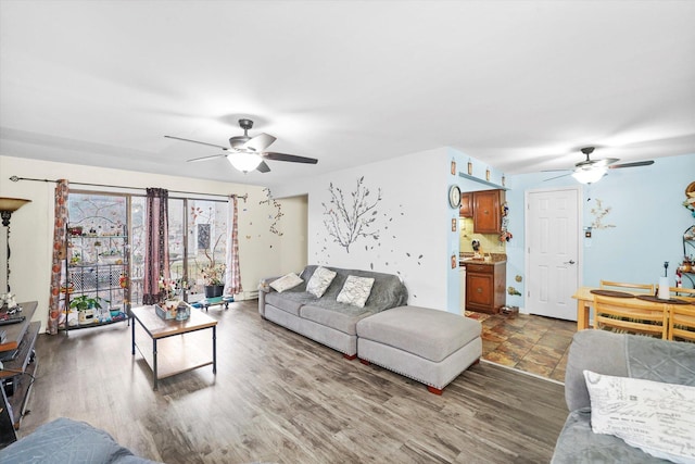 living room featuring a ceiling fan and wood finished floors