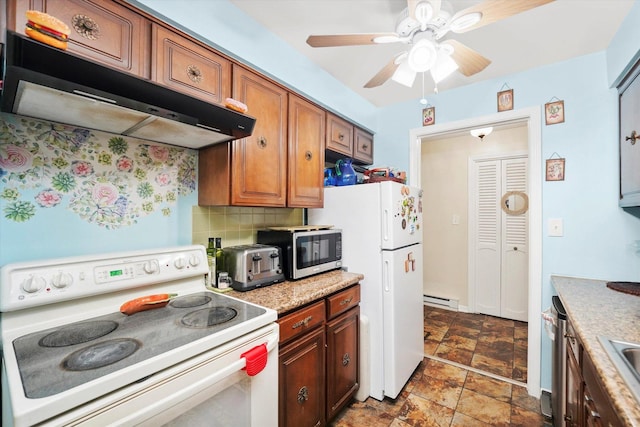 kitchen with white appliances, baseboard heating, extractor fan, light countertops, and backsplash