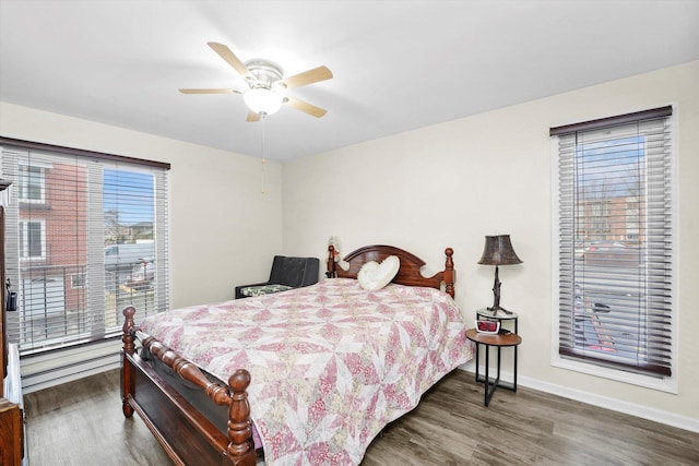 bedroom featuring dark wood-style flooring, ceiling fan, and baseboards