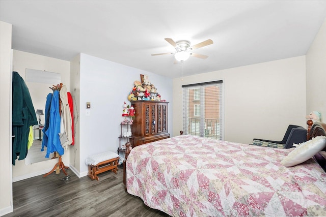 bedroom featuring dark wood-style flooring, ceiling fan, and baseboards