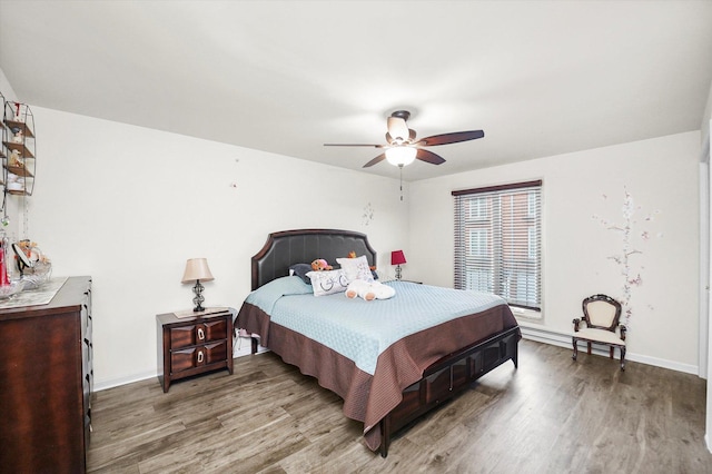 bedroom featuring wood finished floors, a ceiling fan, and baseboards