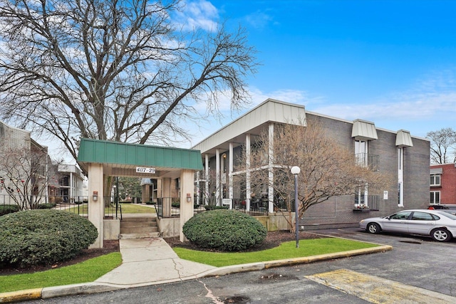 view of building exterior featuring uncovered parking