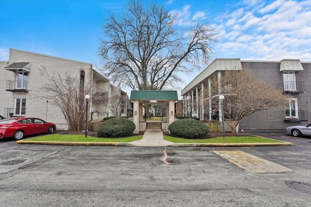 view of building exterior with uncovered parking