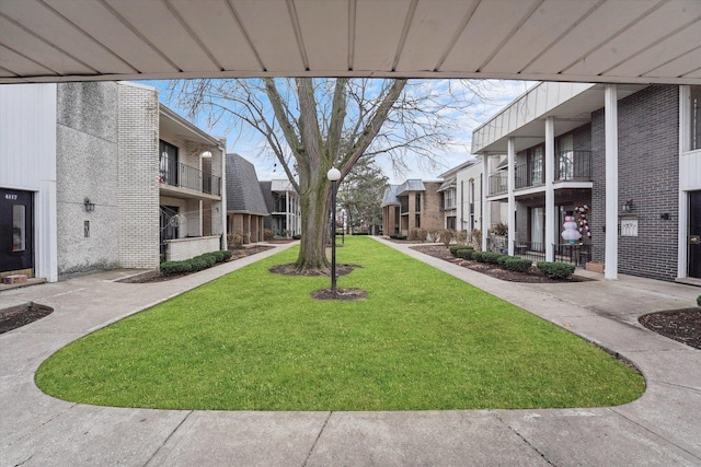 view of community with a residential view and a yard