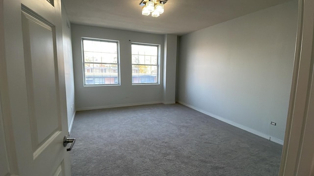 unfurnished room with baseboards and carpet flooring