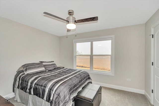 bedroom with light colored carpet, ceiling fan, and baseboards