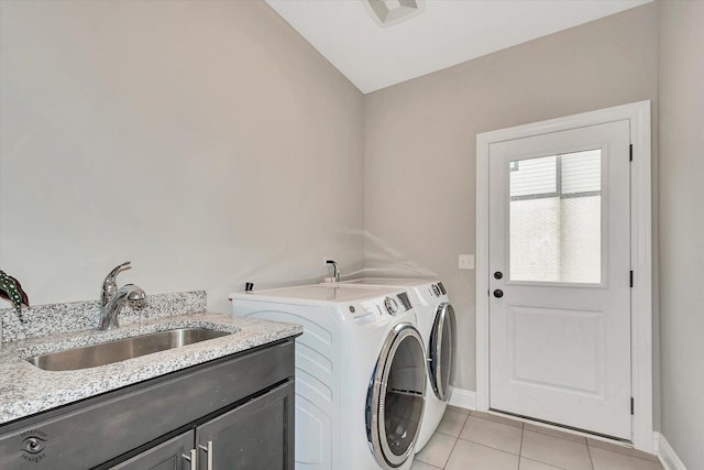 clothes washing area featuring light tile patterned floors, cabinet space, a sink, independent washer and dryer, and baseboards