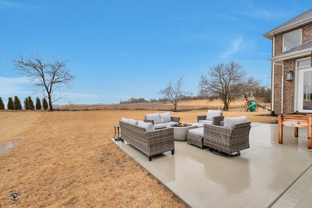 view of patio / terrace featuring a playground, outdoor lounge area, and a rural view